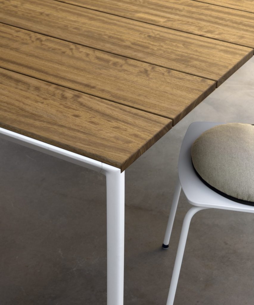 dining table made of metal or wood base and aluminum top in a coffe tone