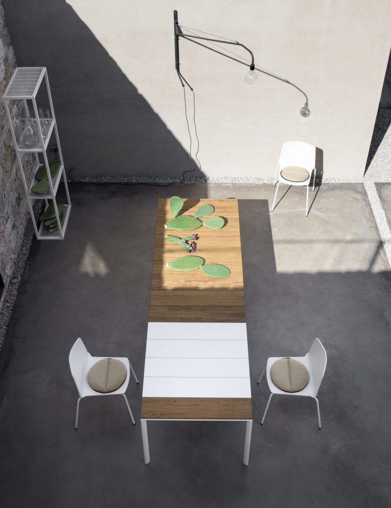 dining table made of metal or wood base and aluminum top in a white and coffe tone