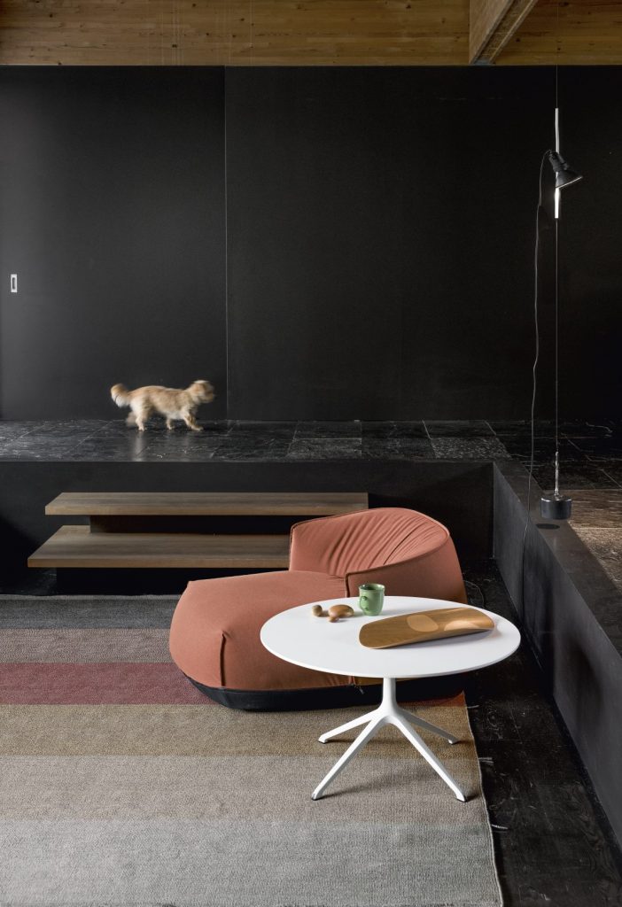 rug made of fabric base in a gray beige coffee and black and red tone on a living room