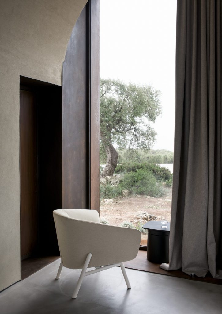 small armchair made of a wooden base and upholstered in white fabric with polyurethane foam