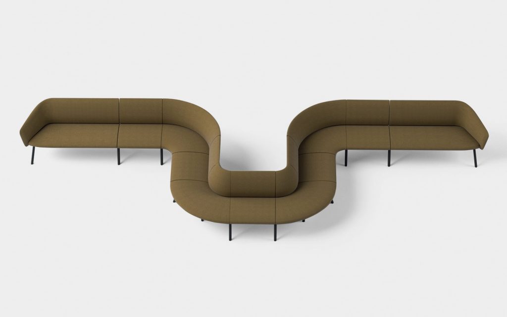 large sofa made from wooden legs covered in light and dark brown fabric with a worm-shaped design
