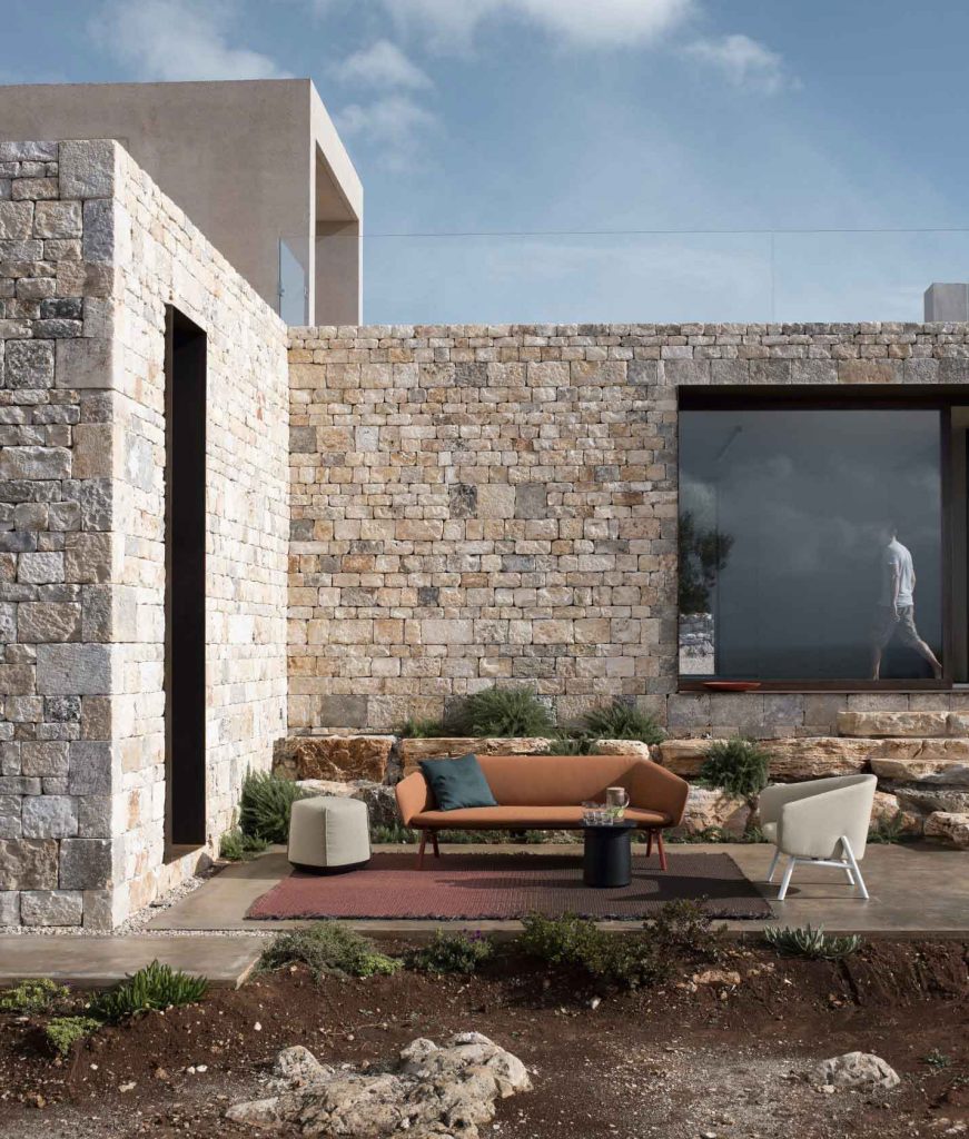 sofa made of fabric base in an orange tone on wooden legs in a black tone