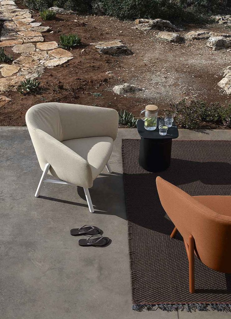 small armchair made of a wooden base and upholstered in white fabric with polyurethane foam on a outside