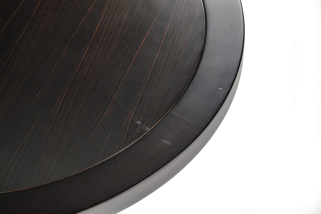 coffee table made in a round shape on a beech wood base in a dark brown tone on a white background