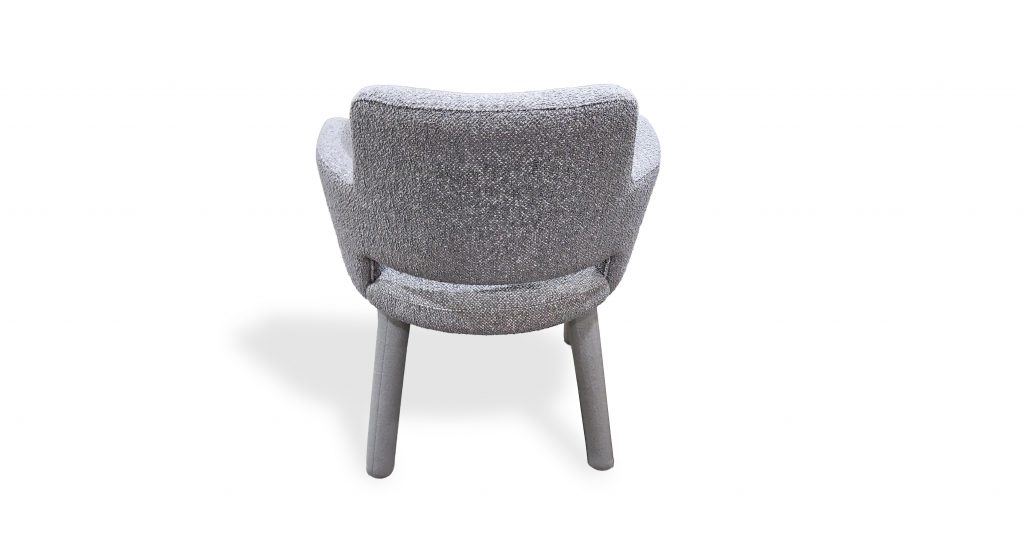 Rear view highlights the chair’s gently rounded back and wraparound arms. Upholstered in textured light gray fabric with matching gray legs, it offers a cohesive, refined look that feels soft, balanced, and well suited for modern interiors.