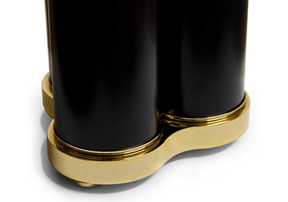 sculptural lamp made of steel base in a black and gold tone on a white background