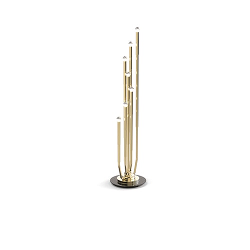 rotating floor lamp made of brass and gold-colored metal and white finishes
