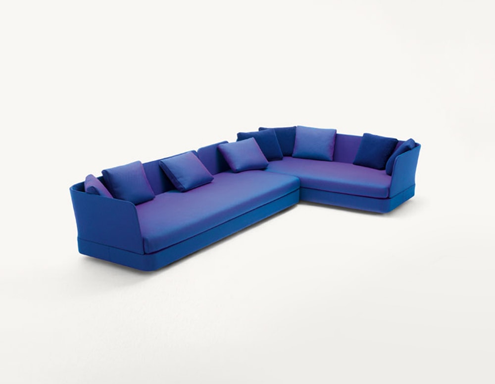 Cove outdoor modular sectional in blue with blue pillows in front of a white background