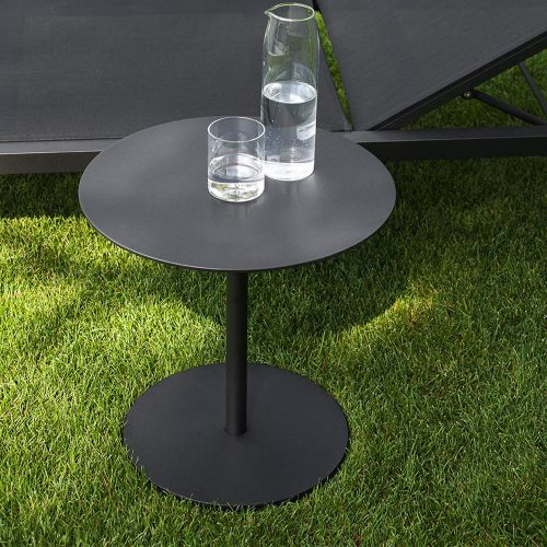 Button Forty Five Side Table outside on top of some grass