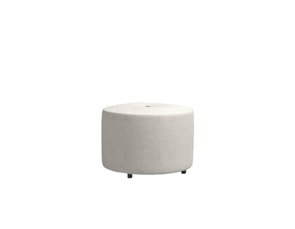 A round outdoor pouf in light beige fabric with a smooth cylindrical shape and low-profile black feet.