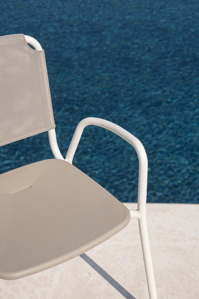 Close up of Guest One Armchair in white by a pool