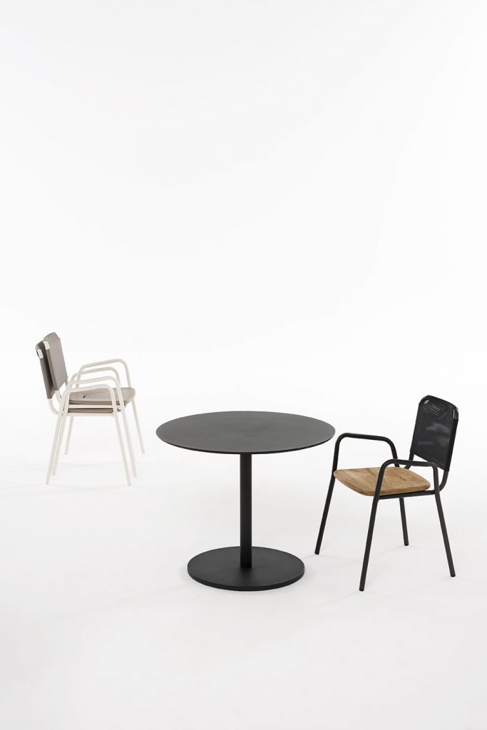 Three Guest One Armchair, two white variants stacked on top of each other and one black variant with a small round table in between