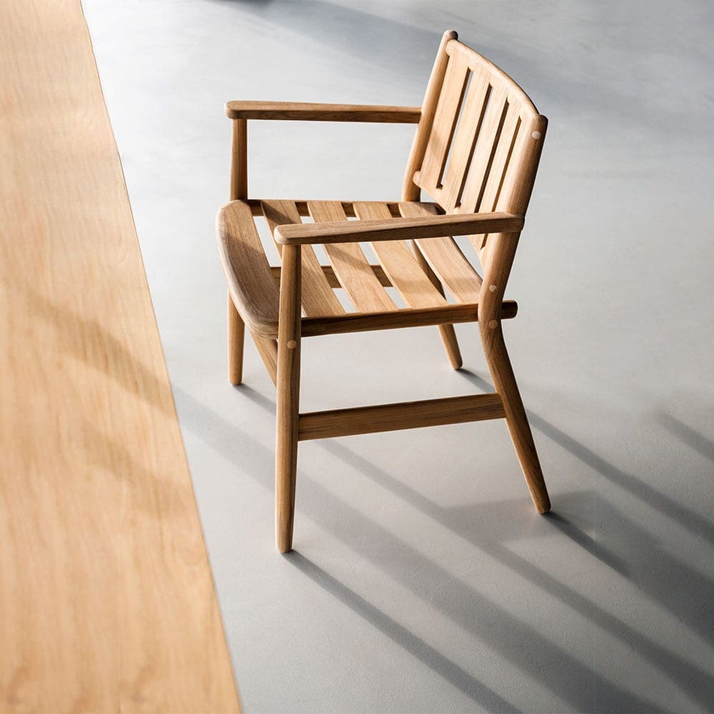 Levante One Armchair in front of a long wooden table