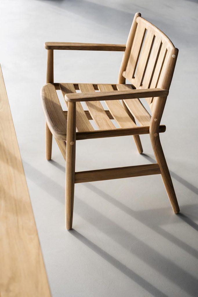 Levante One Armchair in front of a long wooden table