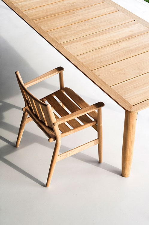 Levante One Armchair in front of a long wooden table