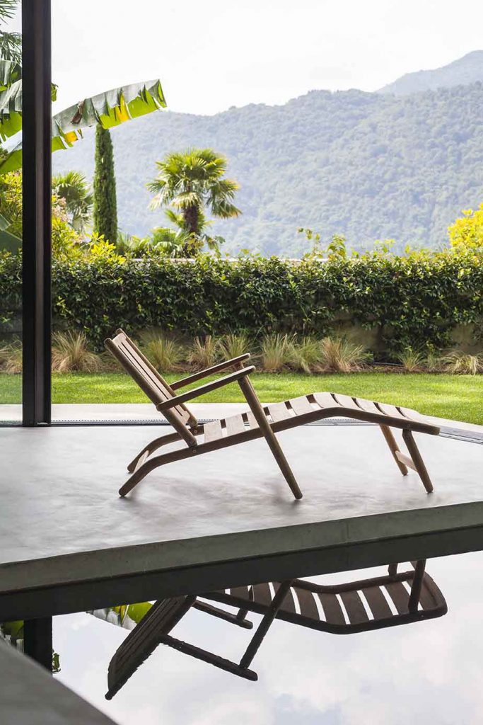 Levante Eight Chaise Longue next to a pool with a mountain in the background