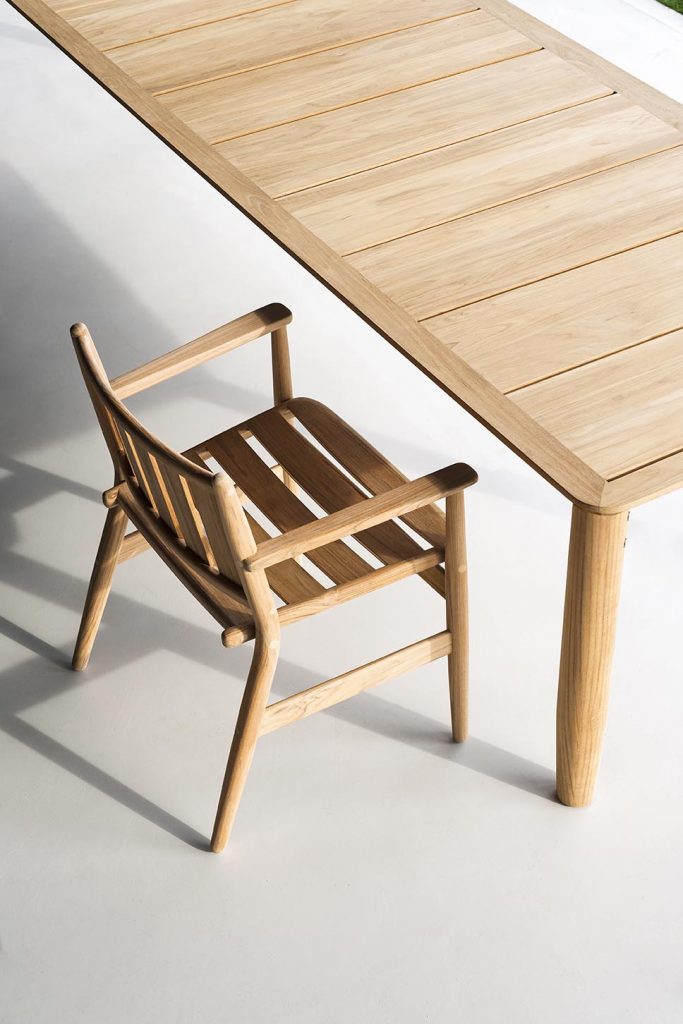 Levante Twenty-Two Table with a wooden chair next to the table