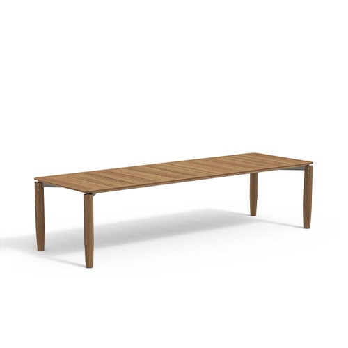 Rod Levante Table features an elongated teak top with slim legs, blending natural warmth and modern simplicity for outdoor dining.
