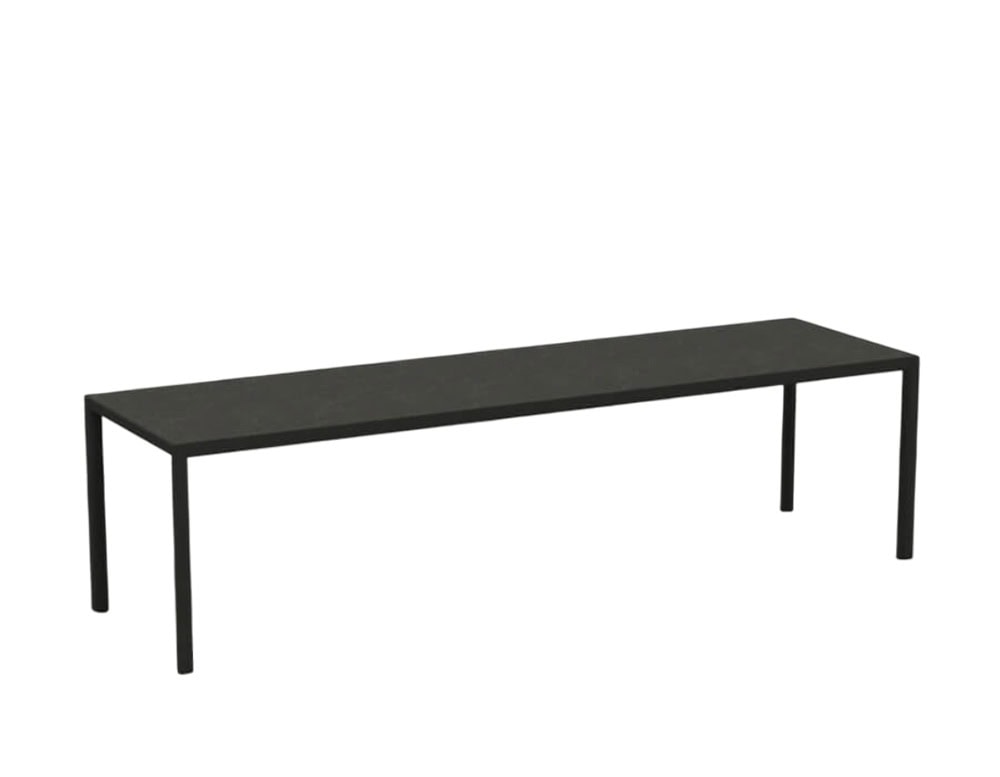 Rod Plein Air Table showcases an elongated black tabletop with slender legs, offering a sleek, understated presence for outdoor gatherings.