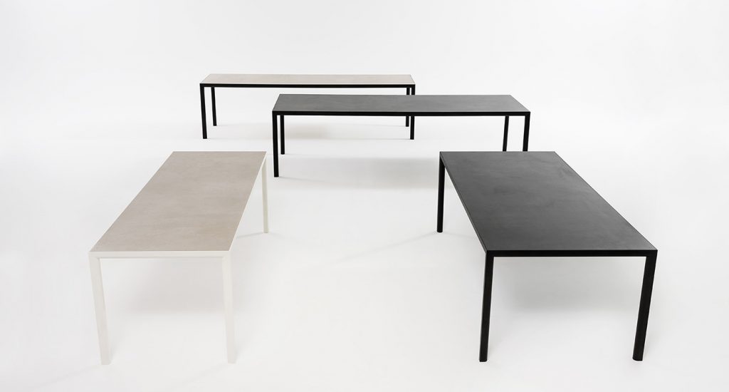 Multiple Plen Air Table in different colors in an all white room