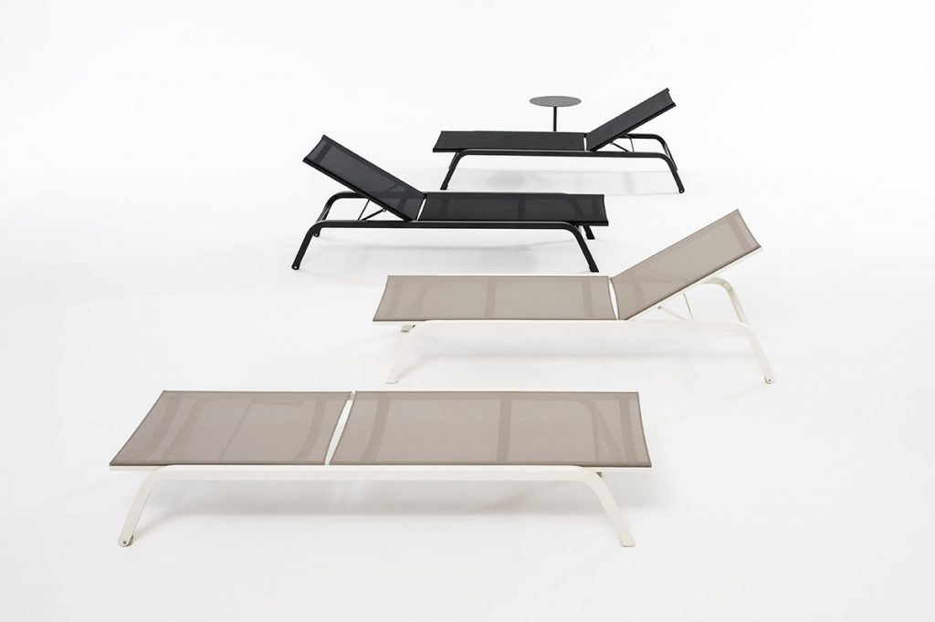 Four Surfer One Sunlounger in white and black variants. One black and one white laying flat and the other black and white have their backrest upwards