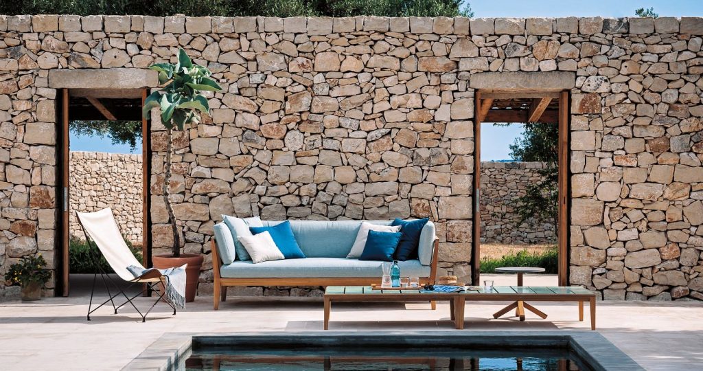 Teka Two Sofa behind a pool with a door both left and right side of the sofa