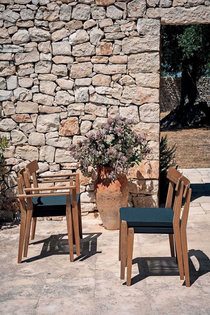 Quad Teka Armchair two facing left and the other two facing right in front of a stone wall
