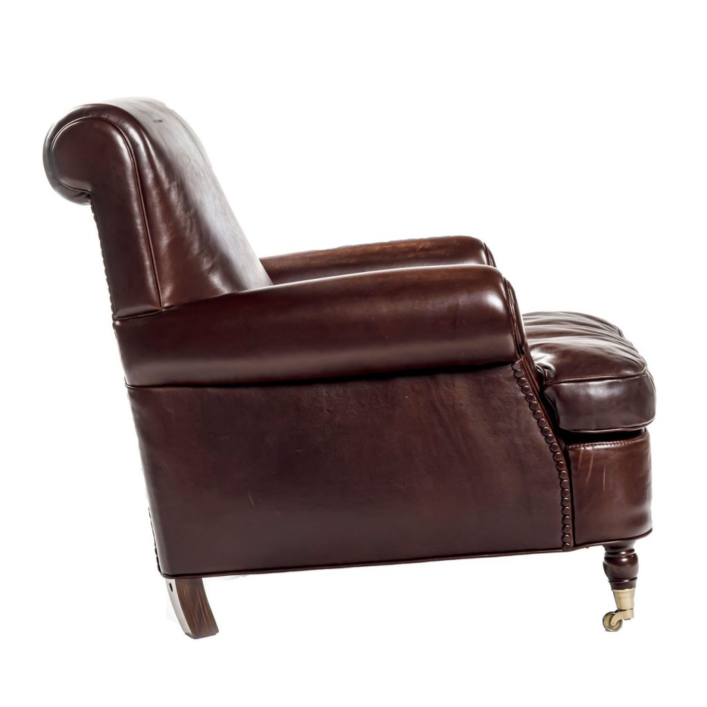 Side view of Charlotte large armchair in brown in front of a white background