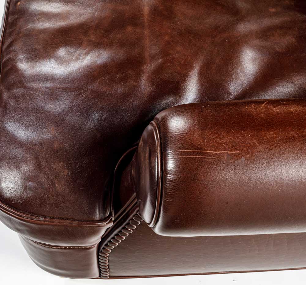 Close up of Charlotte large armchair in brown showing the cushion and armrest