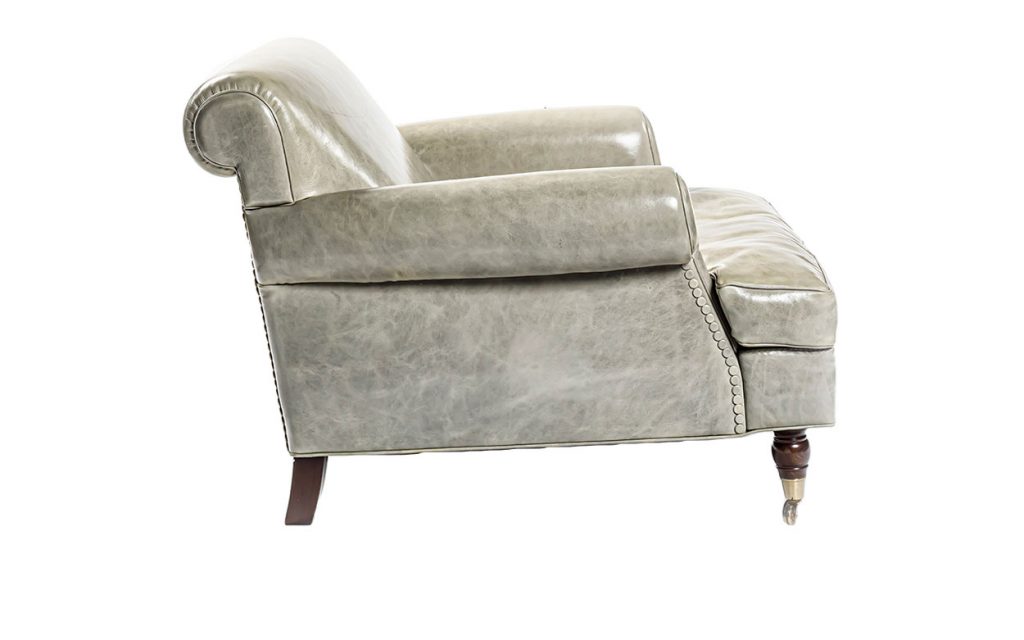 Side view of Charlotte Lounge large armchair in front of a white background