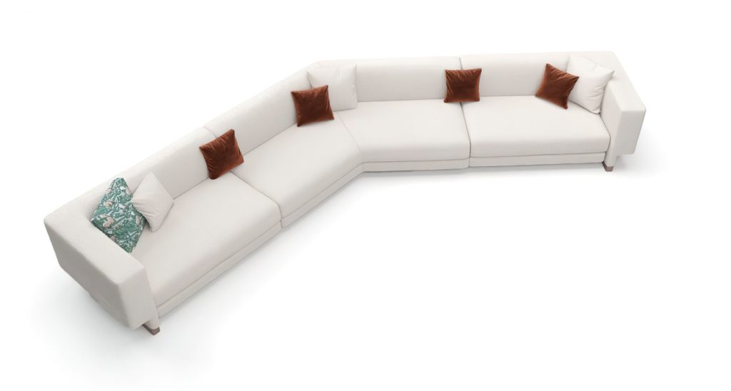 White colored Elissa Sectional with brown pillows in front of a white background