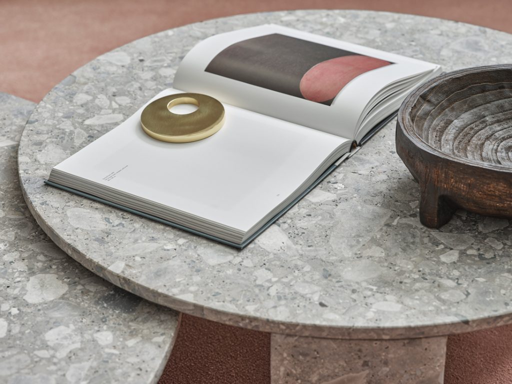 Close up top view of Clemo marble round table with an opened book on top