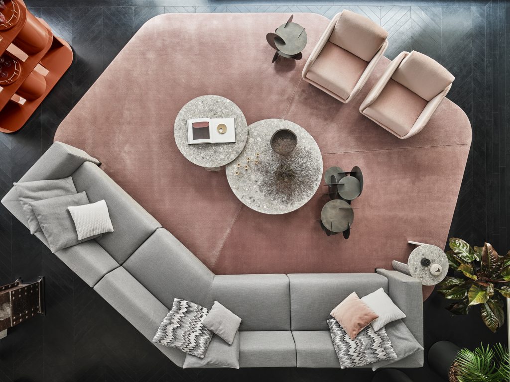 Top view of Resia rug with a pair of pink chairs and a Elissa Sectional grey sofa on top
