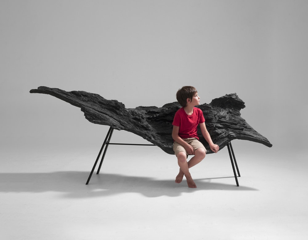 A person sitting on the Verter Turroni Bioma in front of a white background