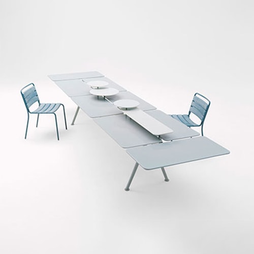 Altopiano table with a chair on both side of the table in front of a white background
