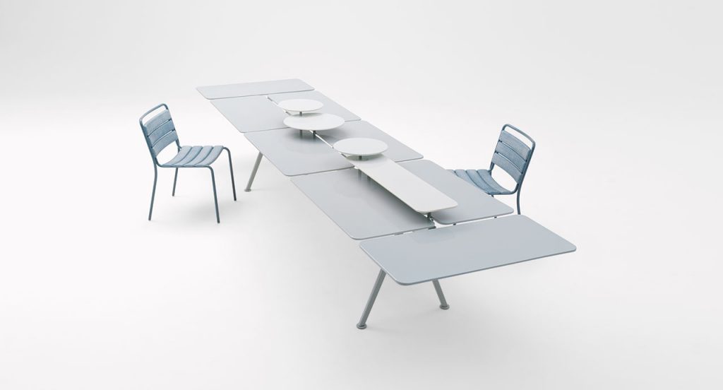 Altopiano table with a chair on both side of the table in front of a white background