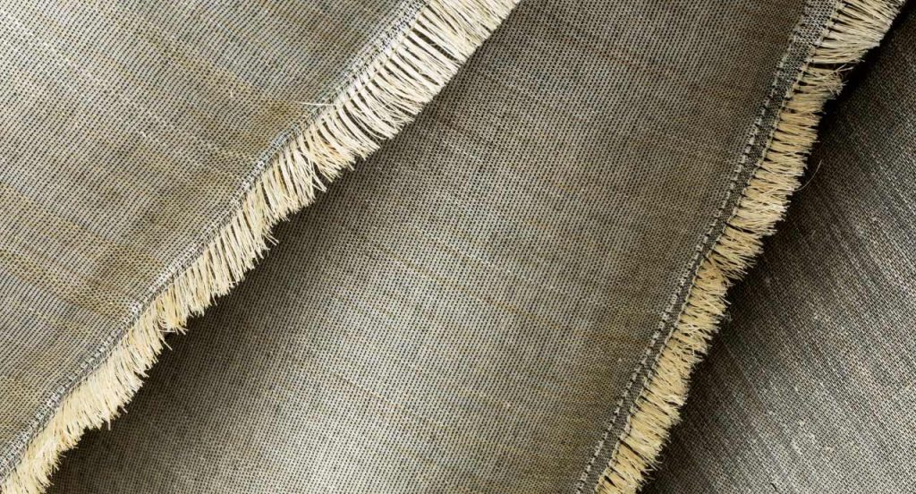 Close up of Cushions Abaca in a grey color showing the fine pattern of the cover