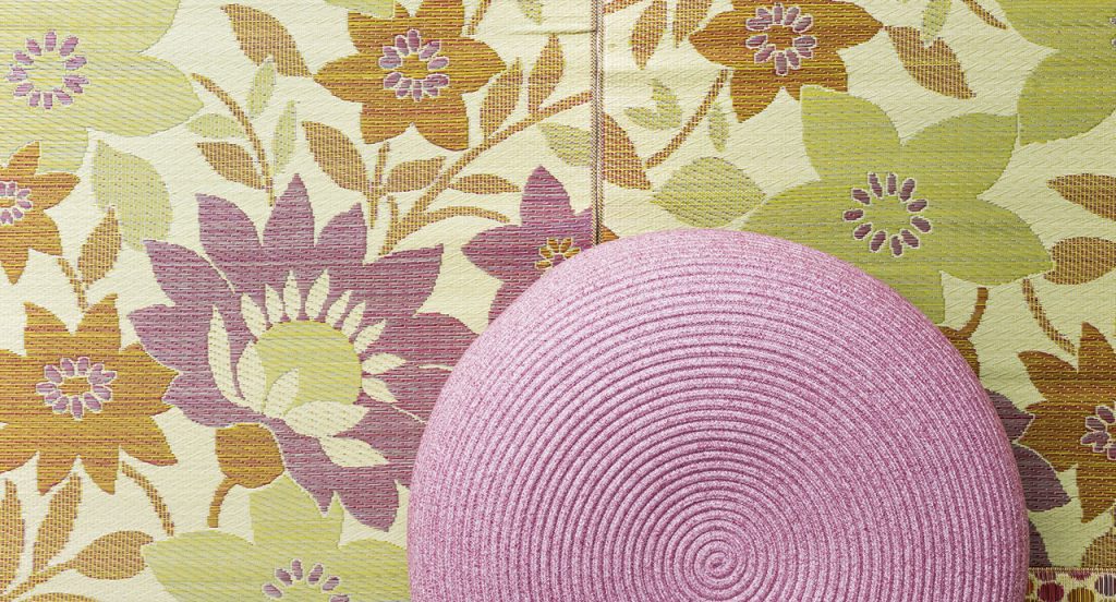 Close up of Otto Pouf two thousand twenty one in a pink color with a floral print background