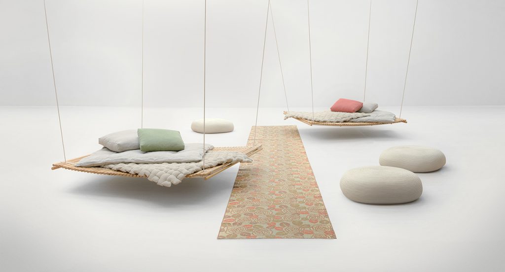 Multiple Shibui Suspended with different colored pillows on each with a tan colored rug running through the middle vertical to the image