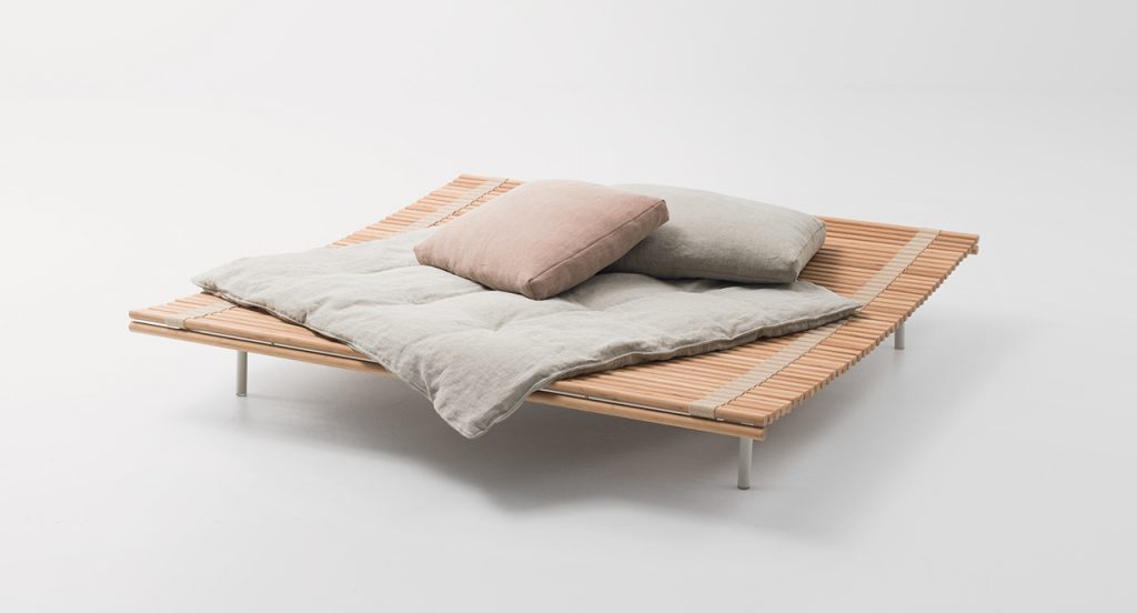 Trapuntino with two pillows on top in front of a white background