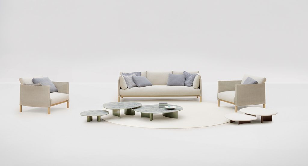 Pair of Vespucci Armchair with a cream colored rug in between them and three small little tables on top of the rug