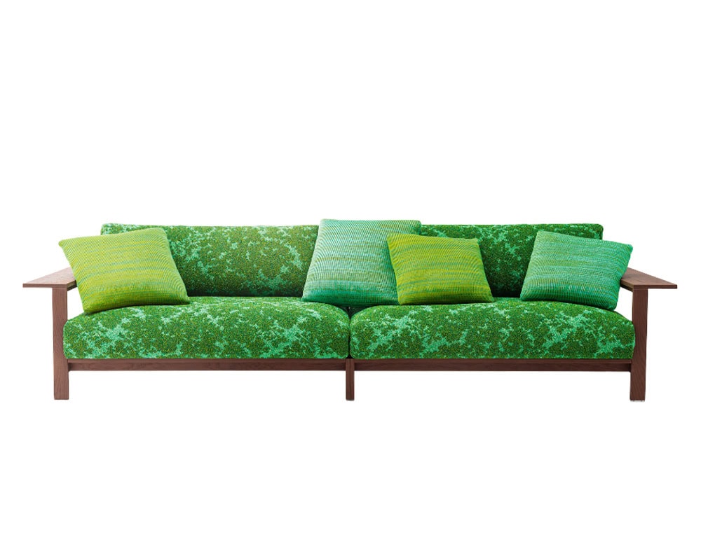 A vibrant outdoor sofa featuring a rich wooden frame and bright green patterned upholstery, complemented by gradient green cushions that evoke a fresh, natural, and inviting atmosphere.