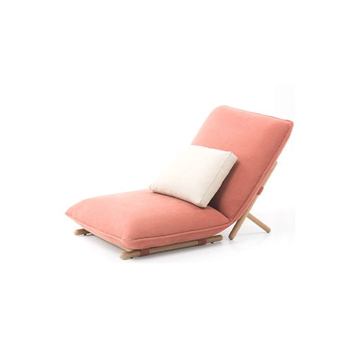 This lounge chair combines a minimal wooden frame with plush coral upholstery and a cream pillow, offering a fresh and elegant look for outdoor relaxation.