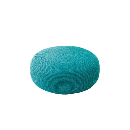 A vibrant round pouf in turquoise brings a bold pop of color and versatile seating. Its woven texture adds depth, making it ideal for both indoor and outdoor spaces.