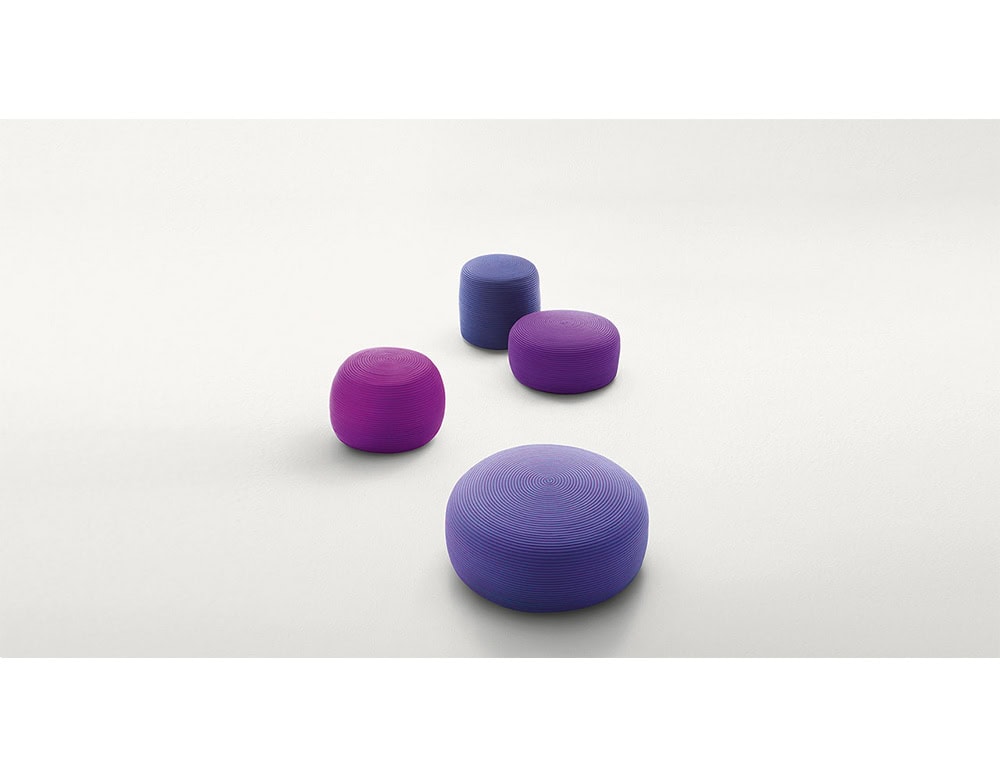A playful collection of outdoor poufs in bold purple and violet tones. With their rounded forms and textured weave, they bring color and versatility to any lounge or patio space.