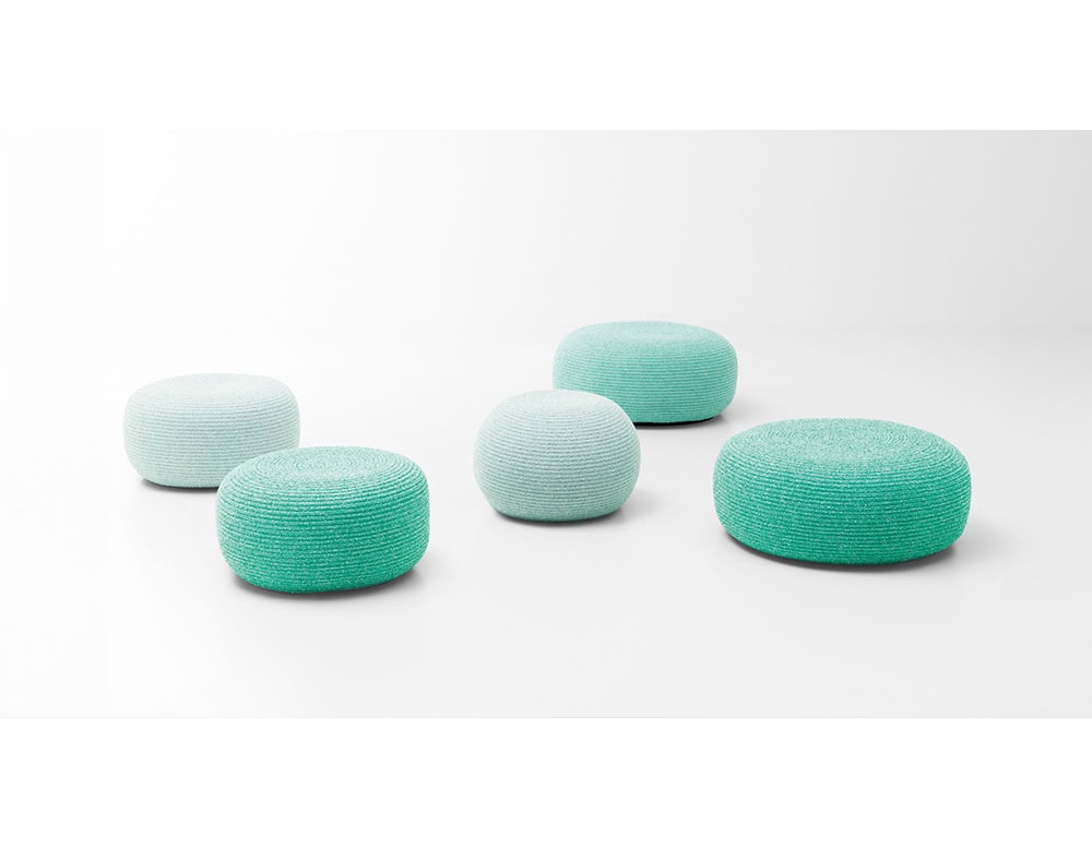 A set of poufs in soft aqua hues that capture a fresh and serene mood. Their woven texture and rounded design make them perfect for versatile outdoor lounging.