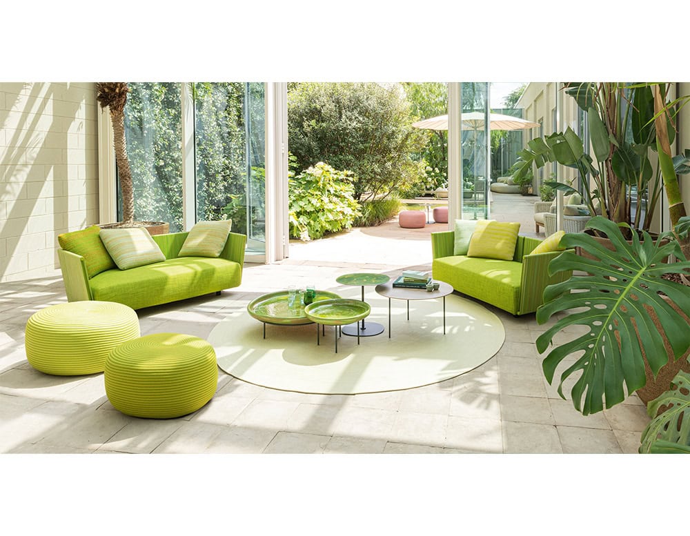 Contemporary seating in vivid green tones creates a playful yet refined atmosphere. Paired with sculptural poufs and minimalist tables, the arrangement turns outdoor living into a statement of style and comfort.