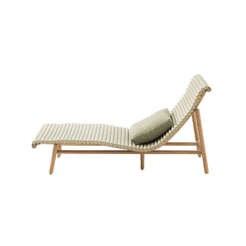 An elongated wooden lounge with rounded slats forming a wave-like profile, complemented by a muted green cushion that adds both texture and relaxation to its refined design.