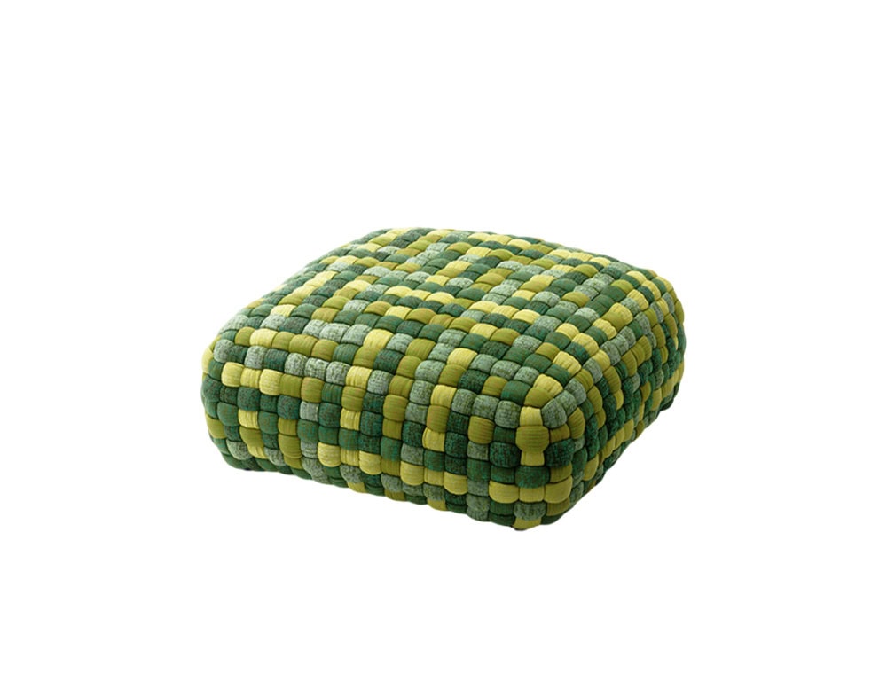 A square pouf with a handwoven effect in shades of green that brings texture and vibrancy to both indoor and outdoor spaces.