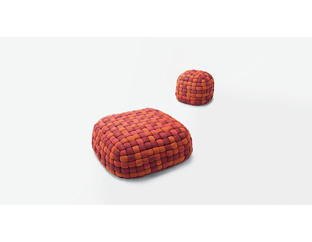 These poufs showcase a bold woven pattern in warm red and orange tones, combining texture and color to create a lively accent that works equally well as seating or a sculptural detail.